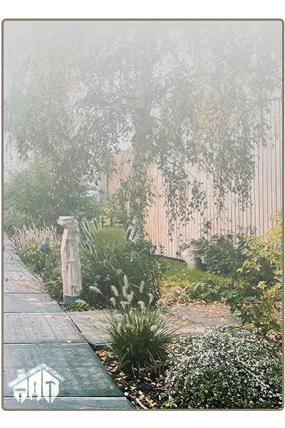lush green bushes & trees divided by a pathway with concrete slabs