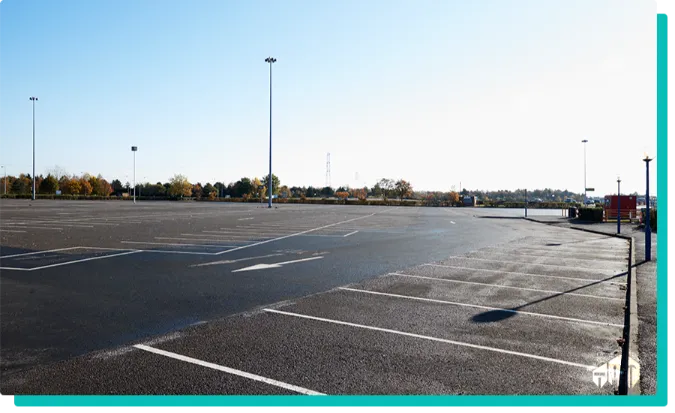 parking lot with a greenery in the background